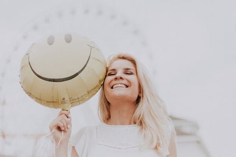 Woman smiling with balloon